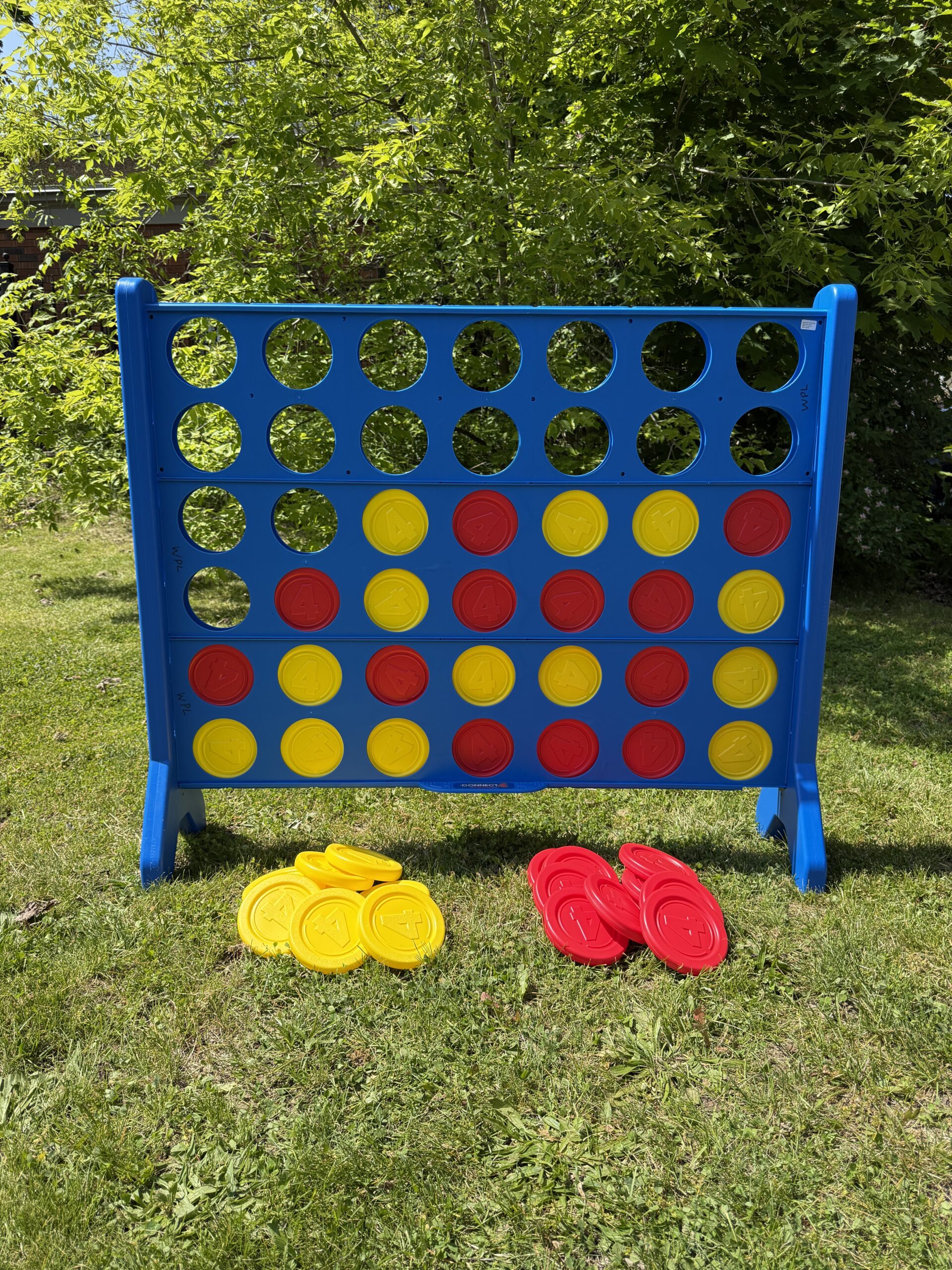 Giant Connect 4 sitting on the grass outside